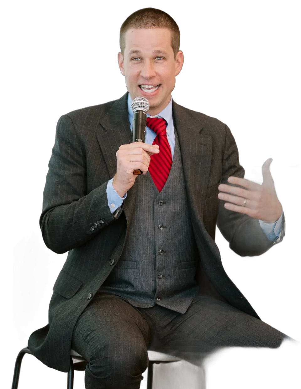 Leroy Hite in a three-piece suit, speaking at a fireside chat